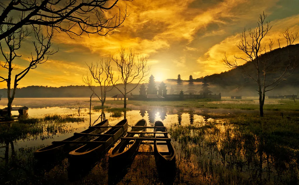 Outrigger boats on Lake Tamblingan at golden hour